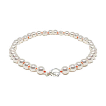 Pearls and orange knots necklace with silver clasp.